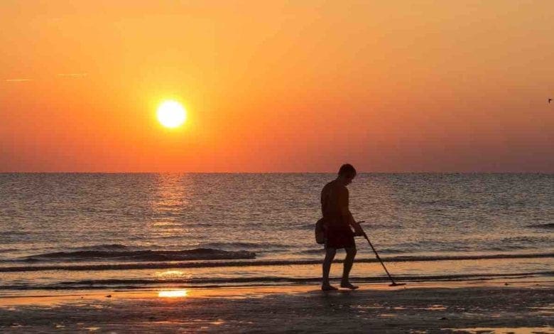 Person with metal detector on Beach