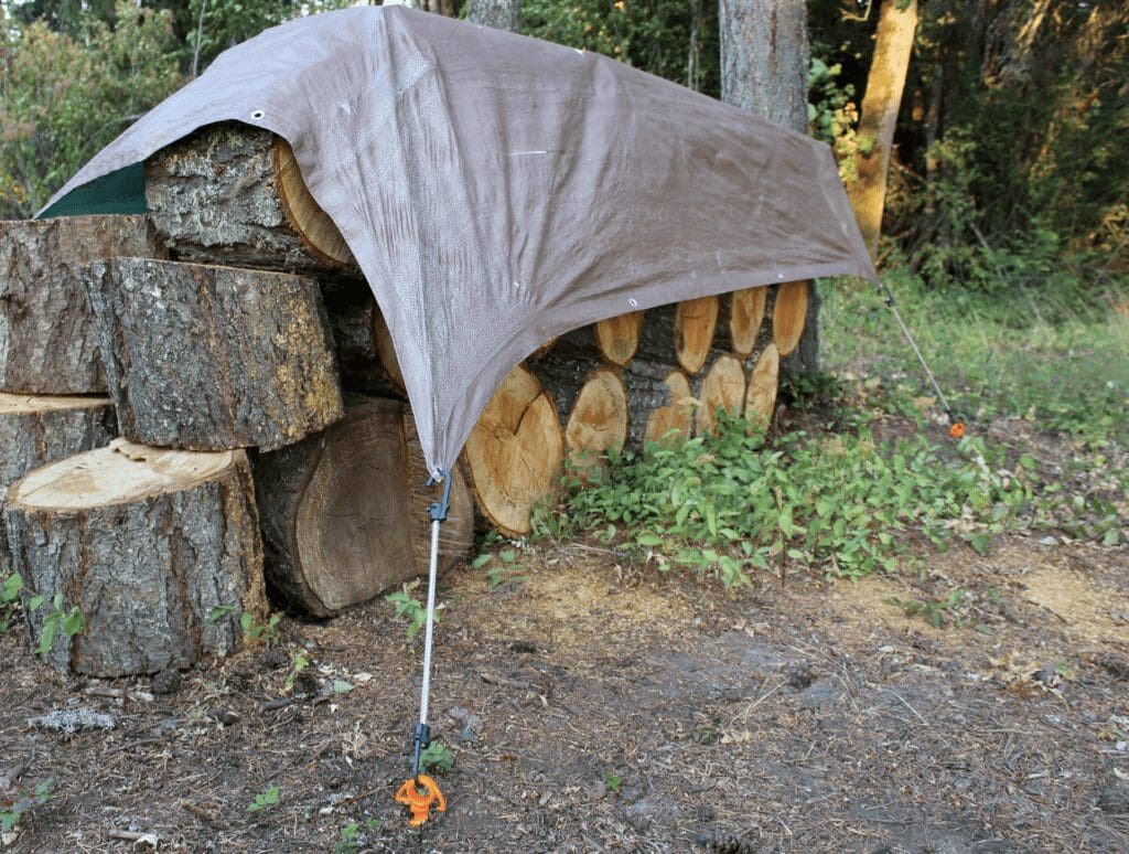 Orange Screw keeping a tarp on the woodpile.
